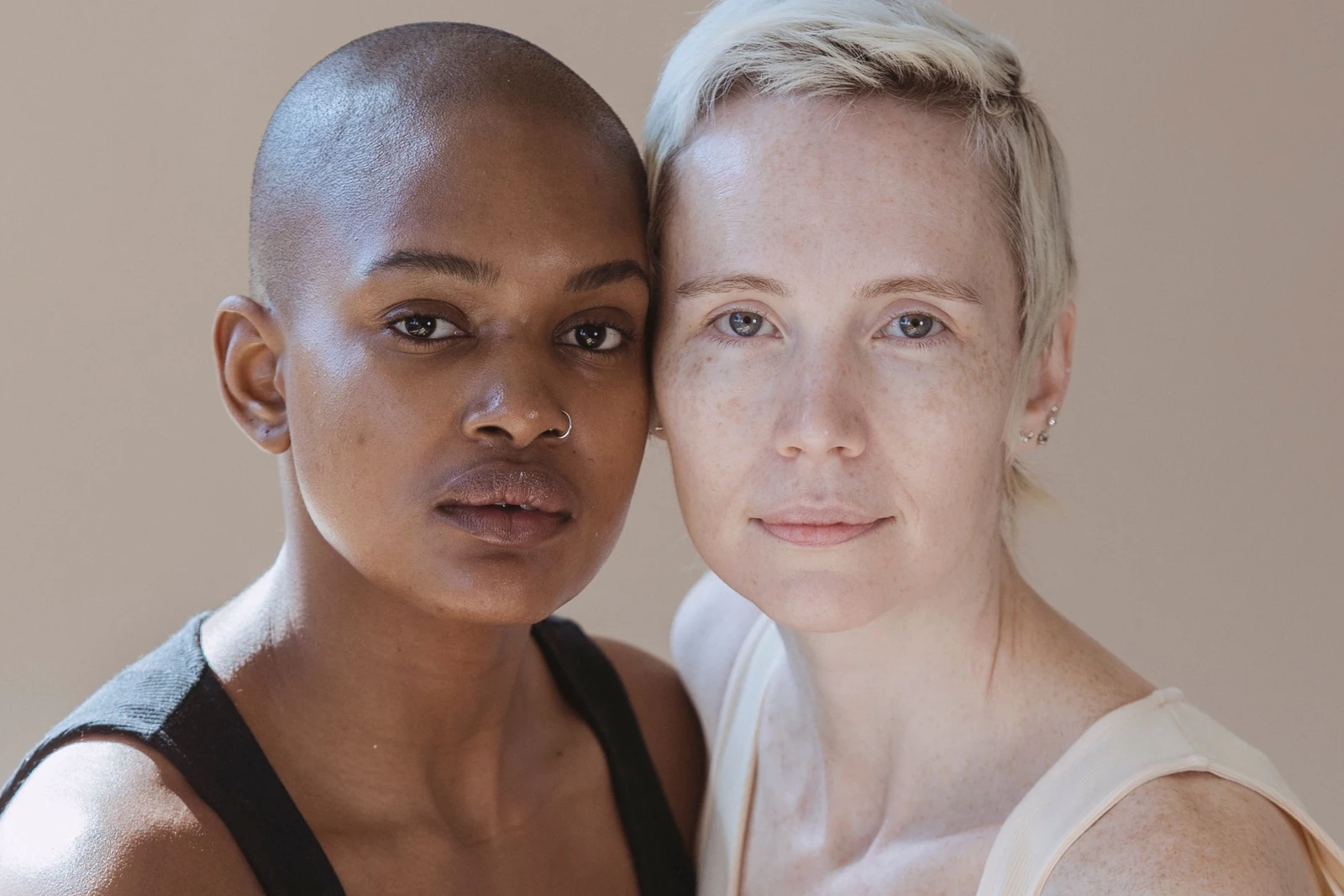 Two adults in a softly lit studio portrait.