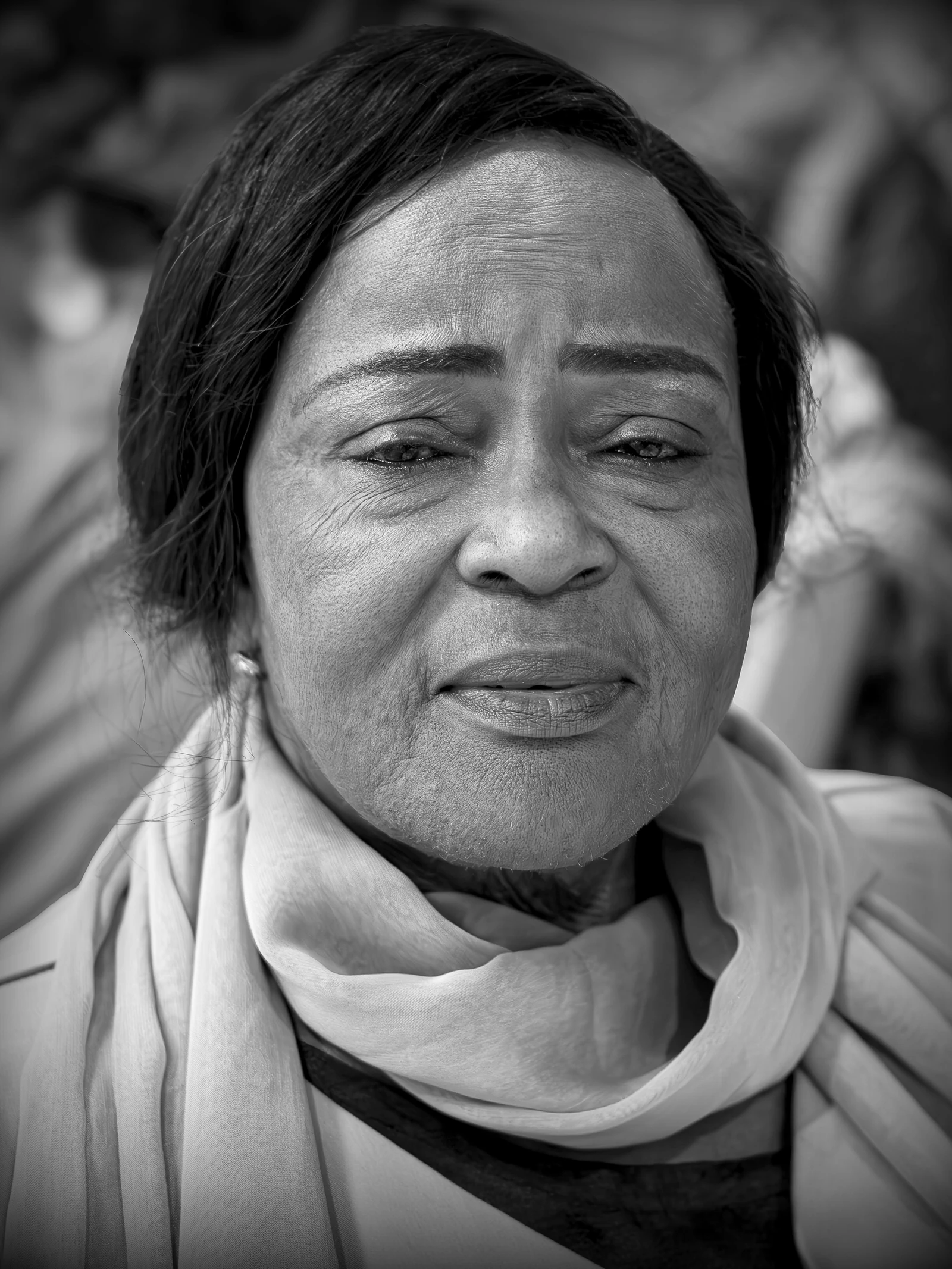 Black-and-white portrait showing natural expression lines.