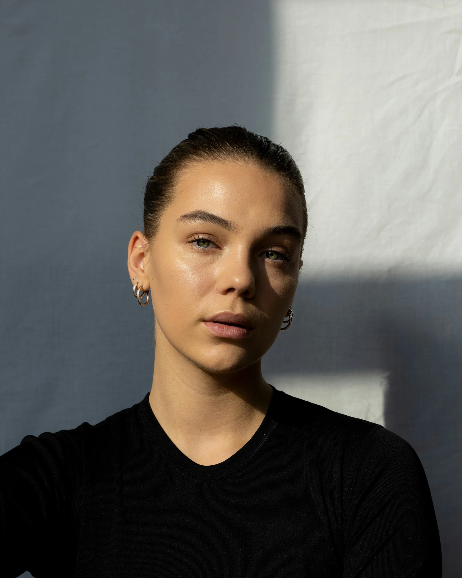 Portrait in soft window light, with natural skin texture.