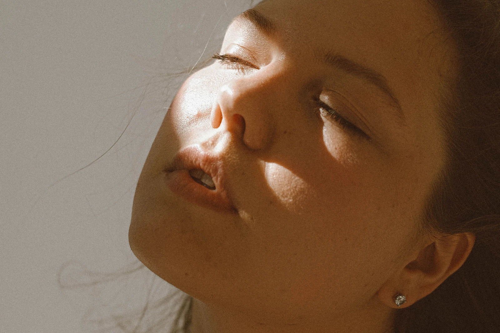 A relaxed face in warm natural light.