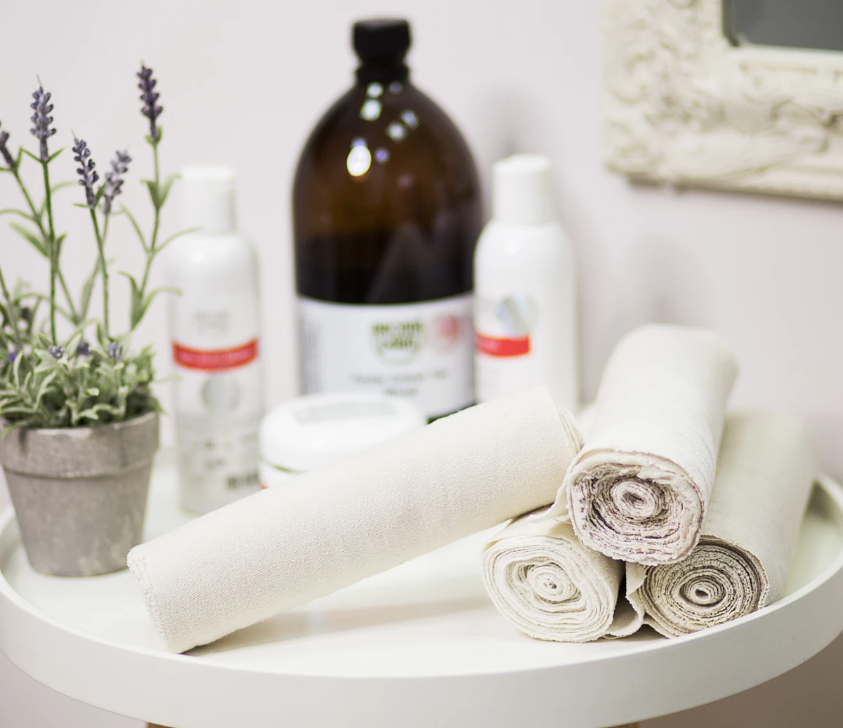 Folded towels and skincare products prepared at BE SPACE.